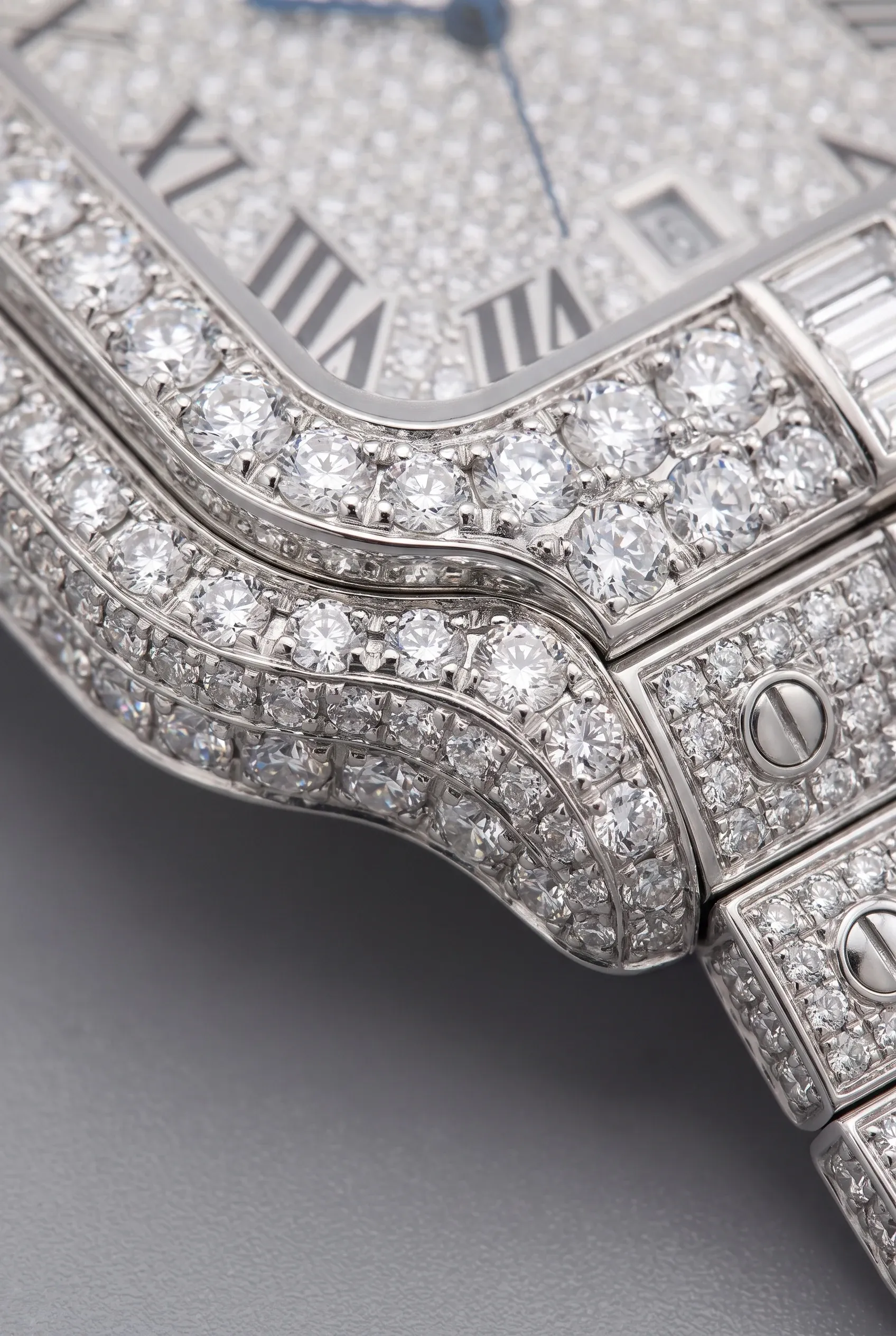 Detailed bezel and bracelet close-up showing small prongs gripping each stone on a fully iced watch.
