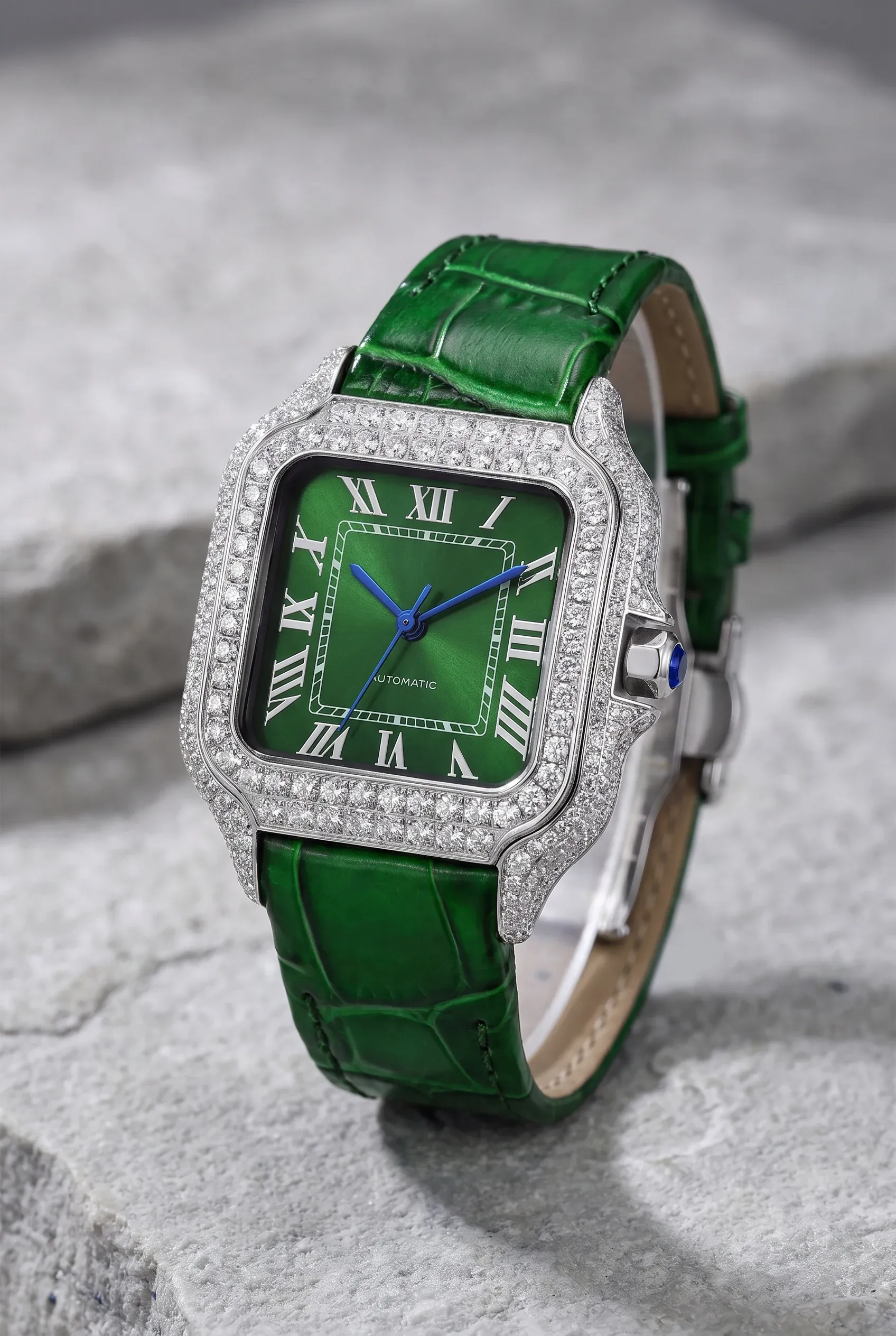 Close-up of a women’s square green dial watch with a stone-set bezel and bracelet.