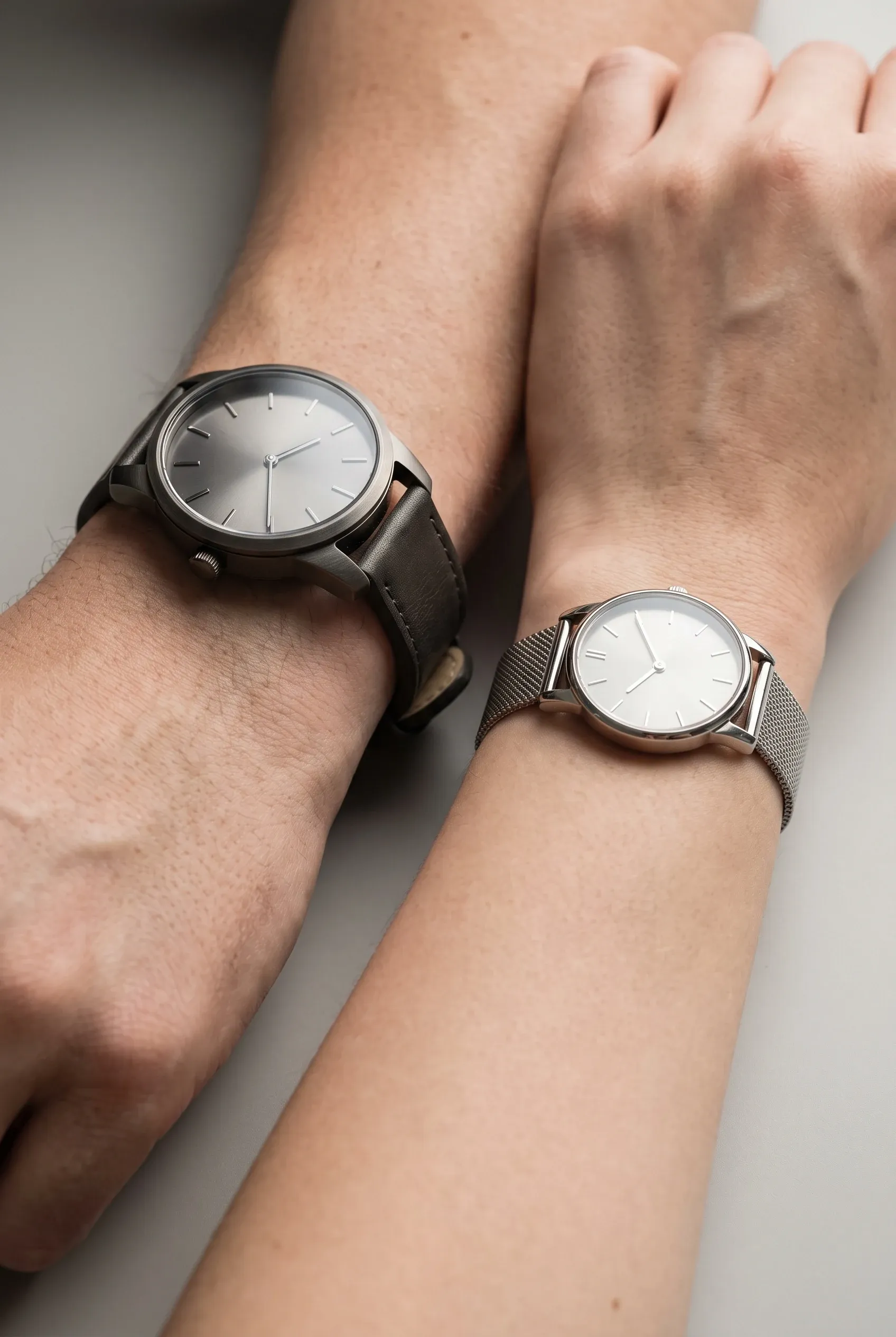 Two wrists wearing different watch sizes to show case proportion and lug overhang clearly.