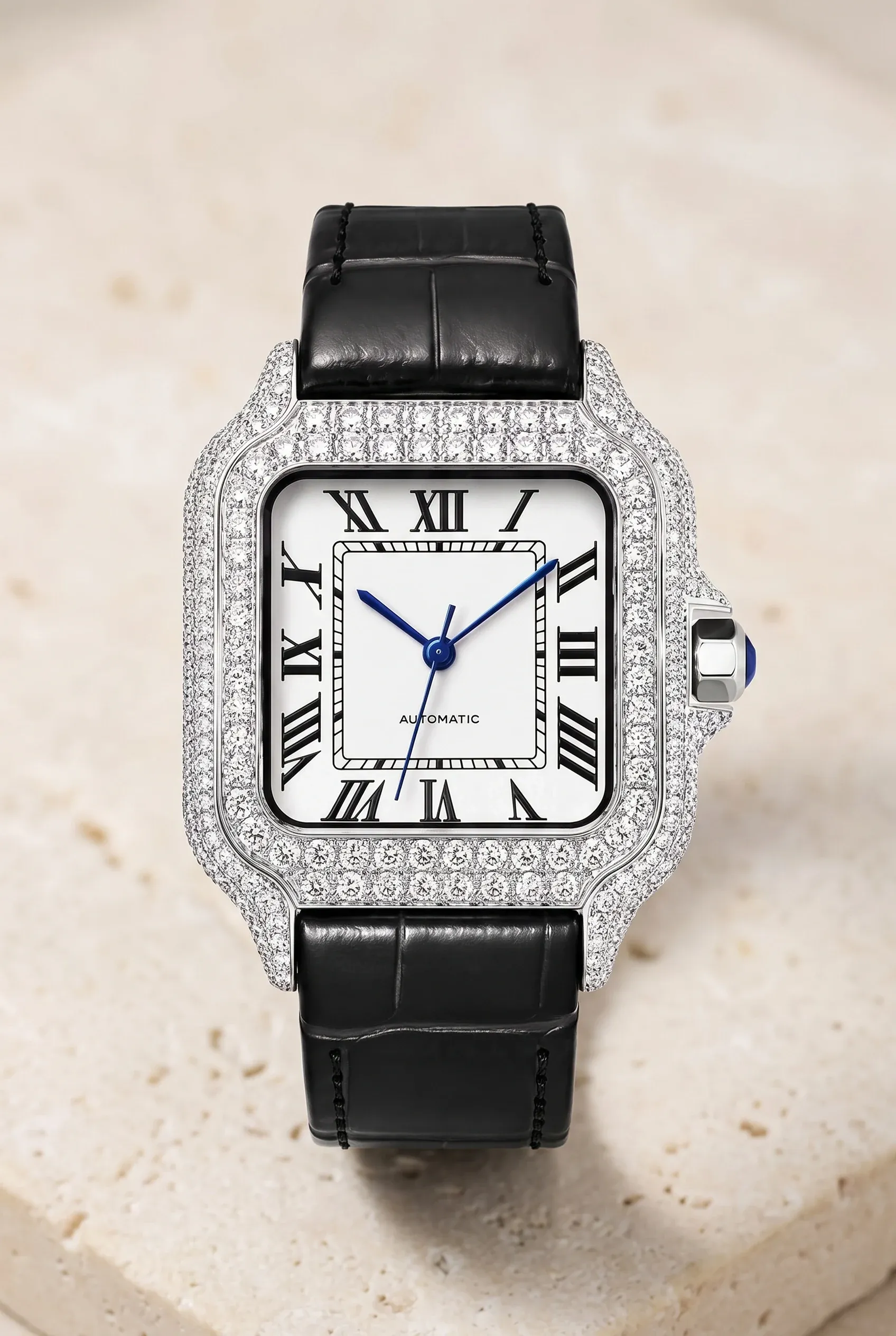 Square women's stone-set watch on a leather strap, shown close-up to emphasize compact case and dressy sparkle.